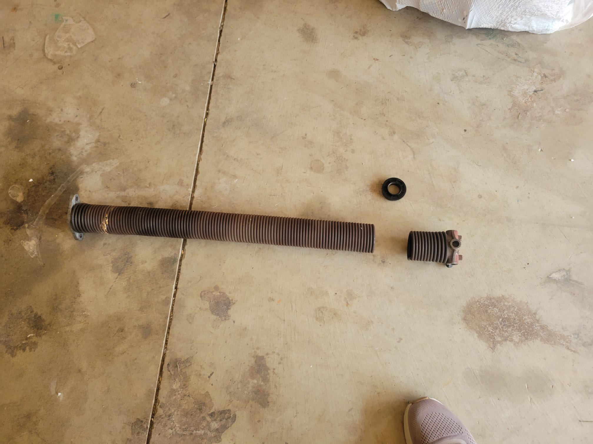 Damaged garage door spring before replacement
