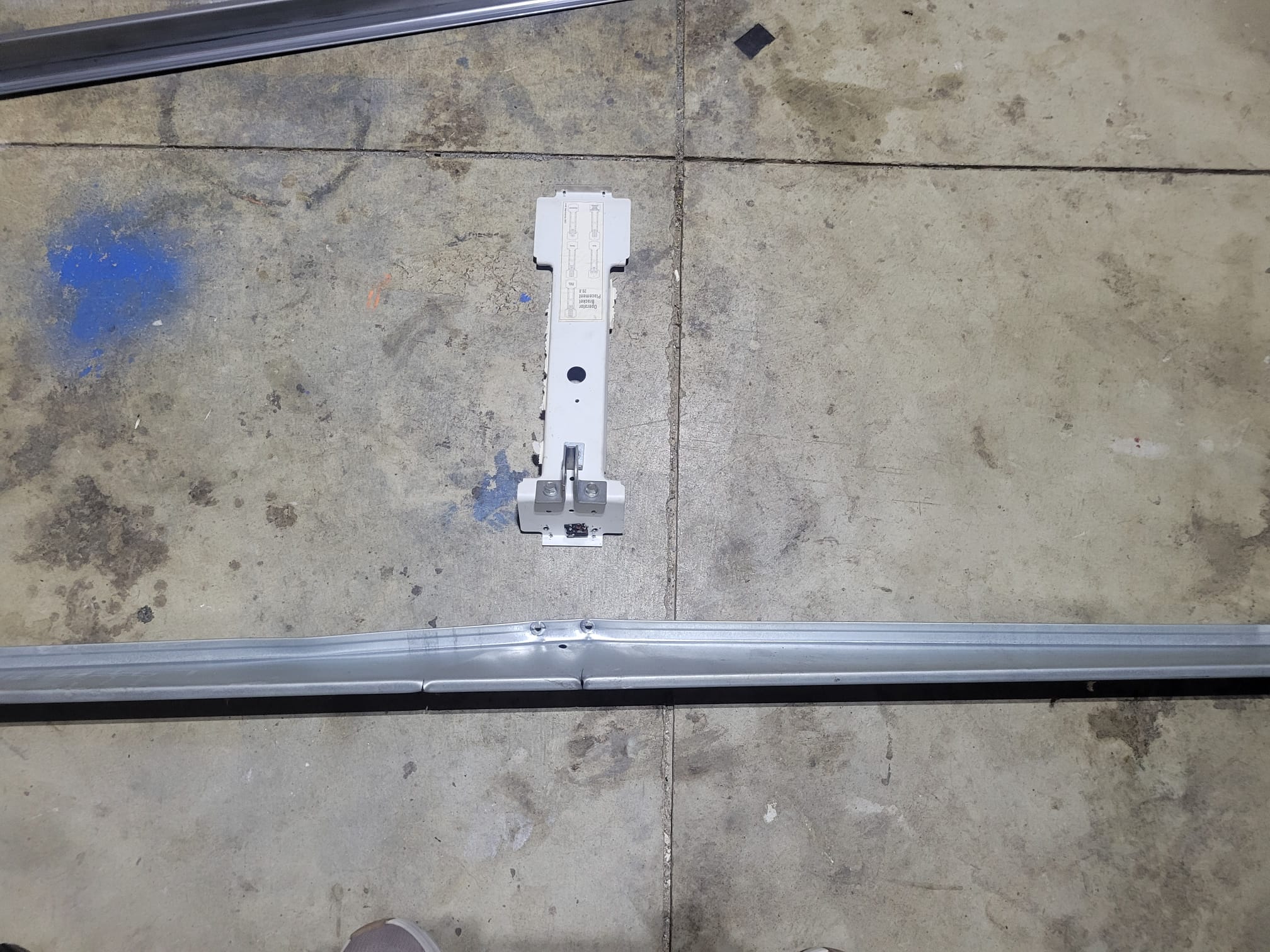 Broken garage door support bracket before replacement