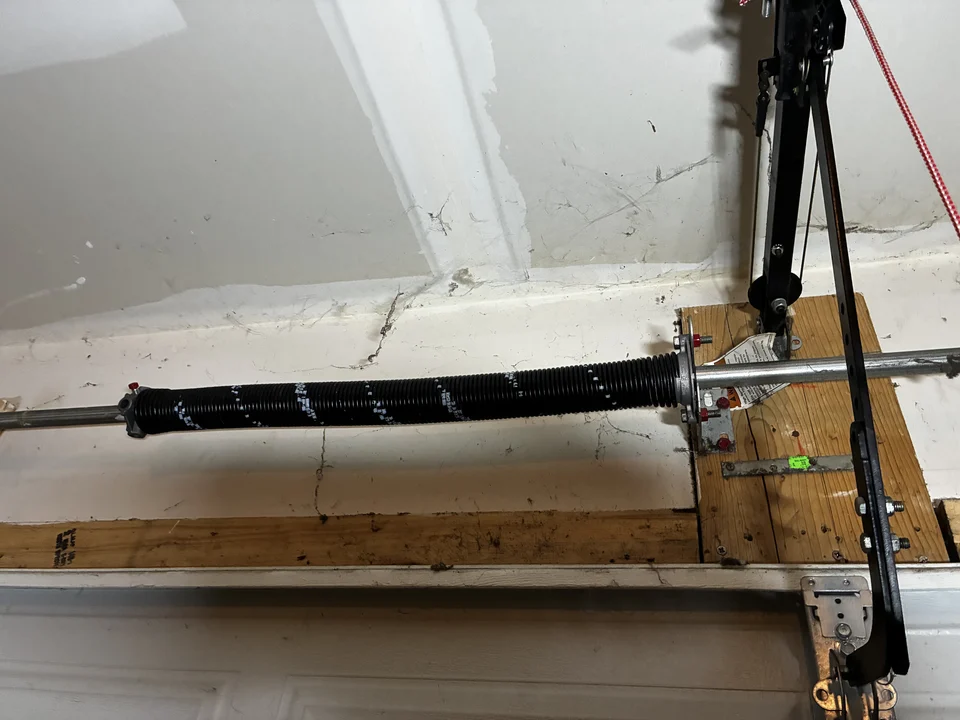New garage door spring installed after replacement