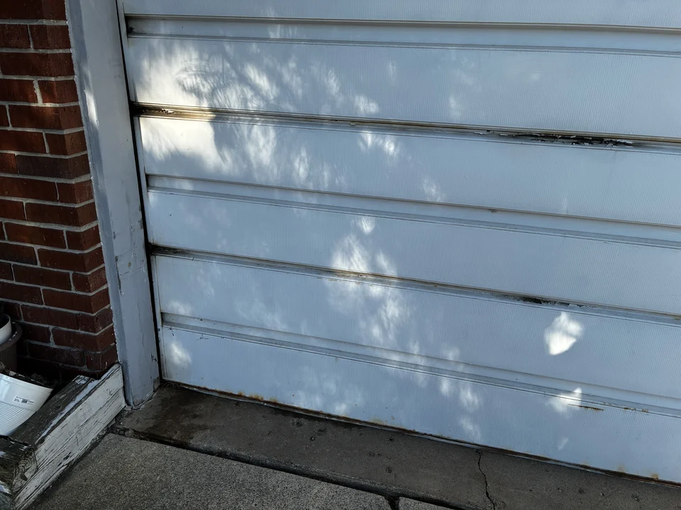 Old residential garage door exterior before replacement