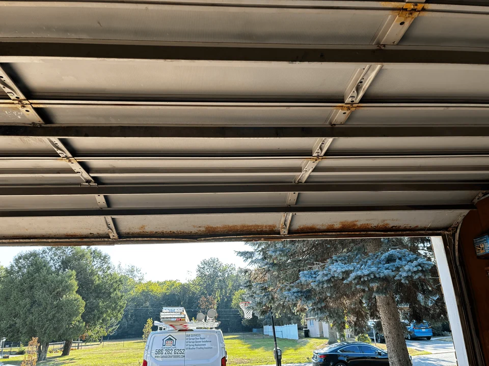 Old residential garage door viewed from above before replacement
