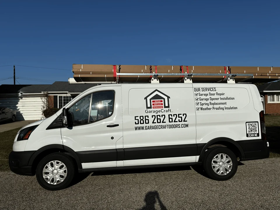 GarageCraft branded service van carrying a garage door