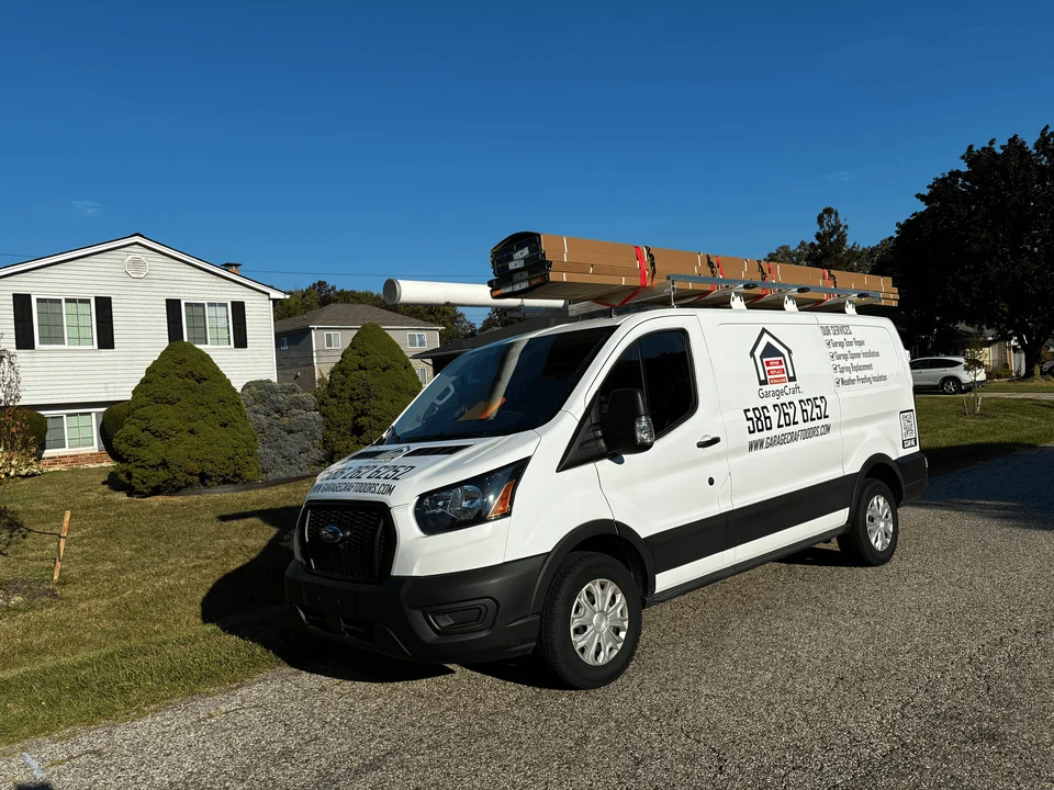 GarageCraft branded service van loaded with a new garage door