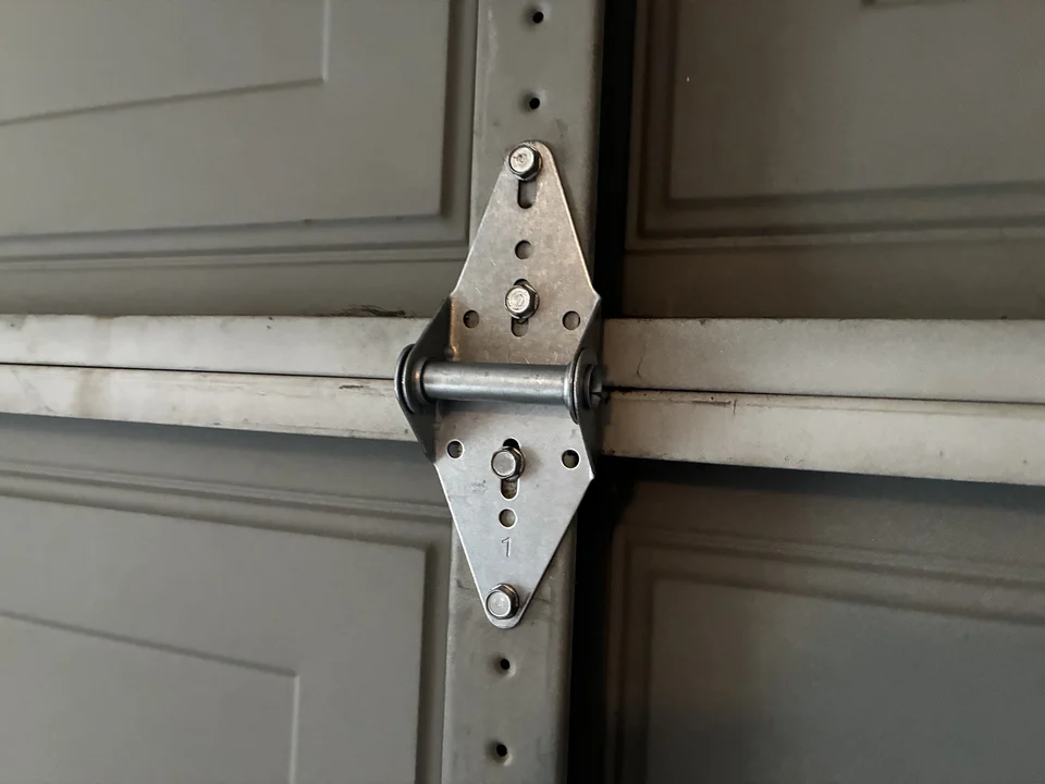 New garage door hinge 2 installed after replacement