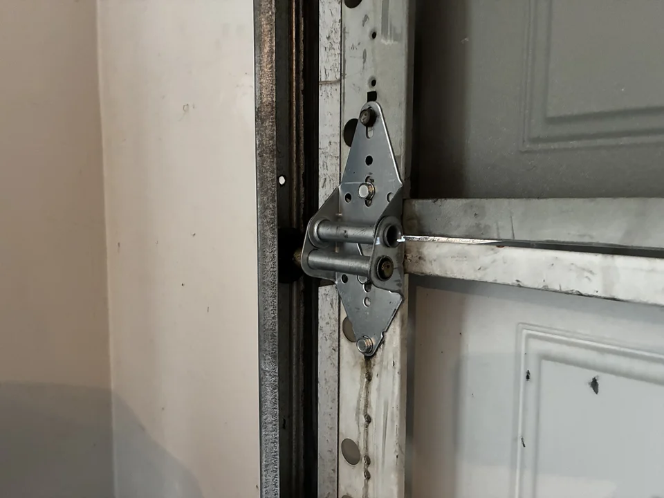 New garage door hinge 3 installed after replacement