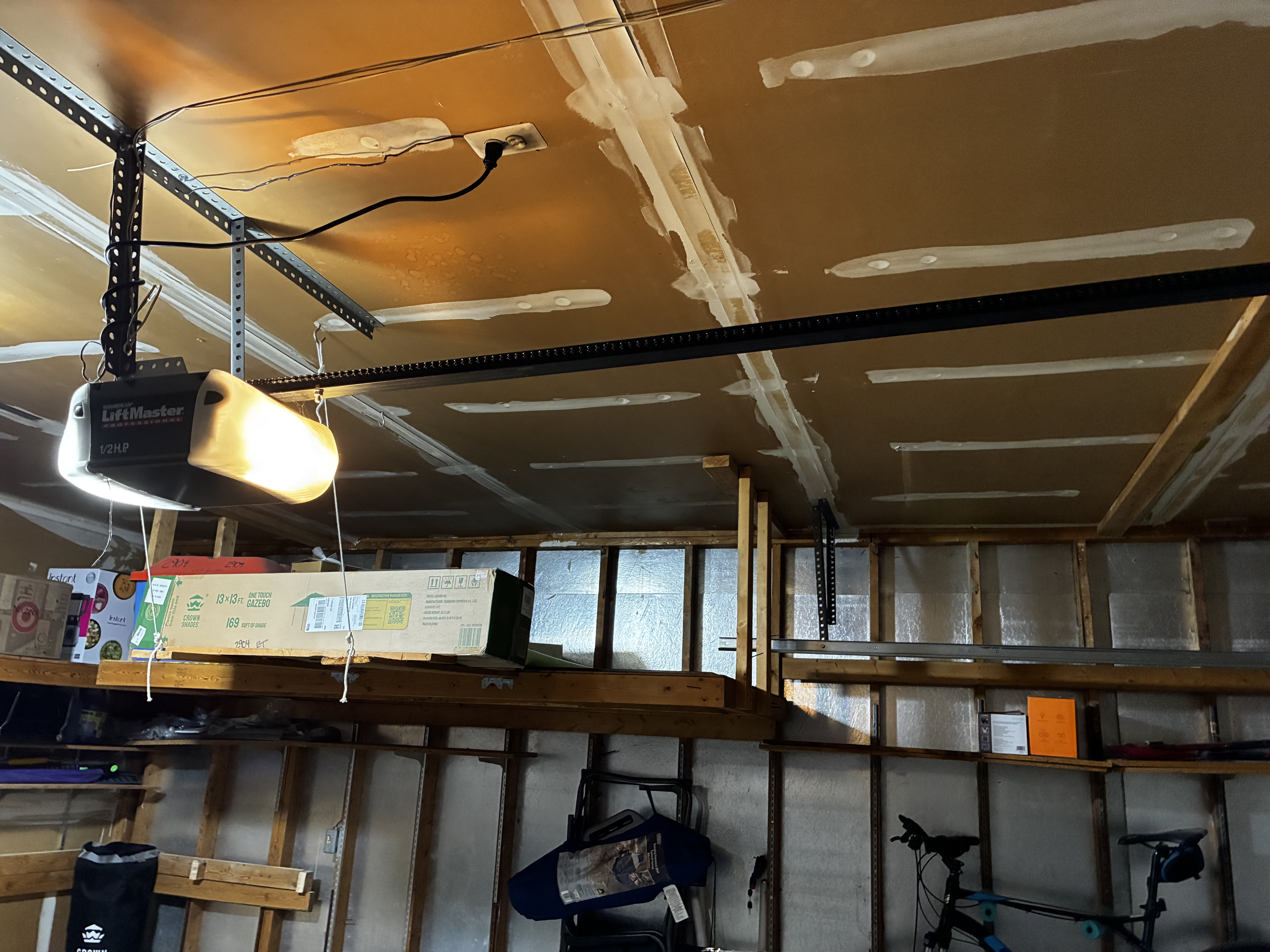 Garage door opener chain tightened and adjusted properly