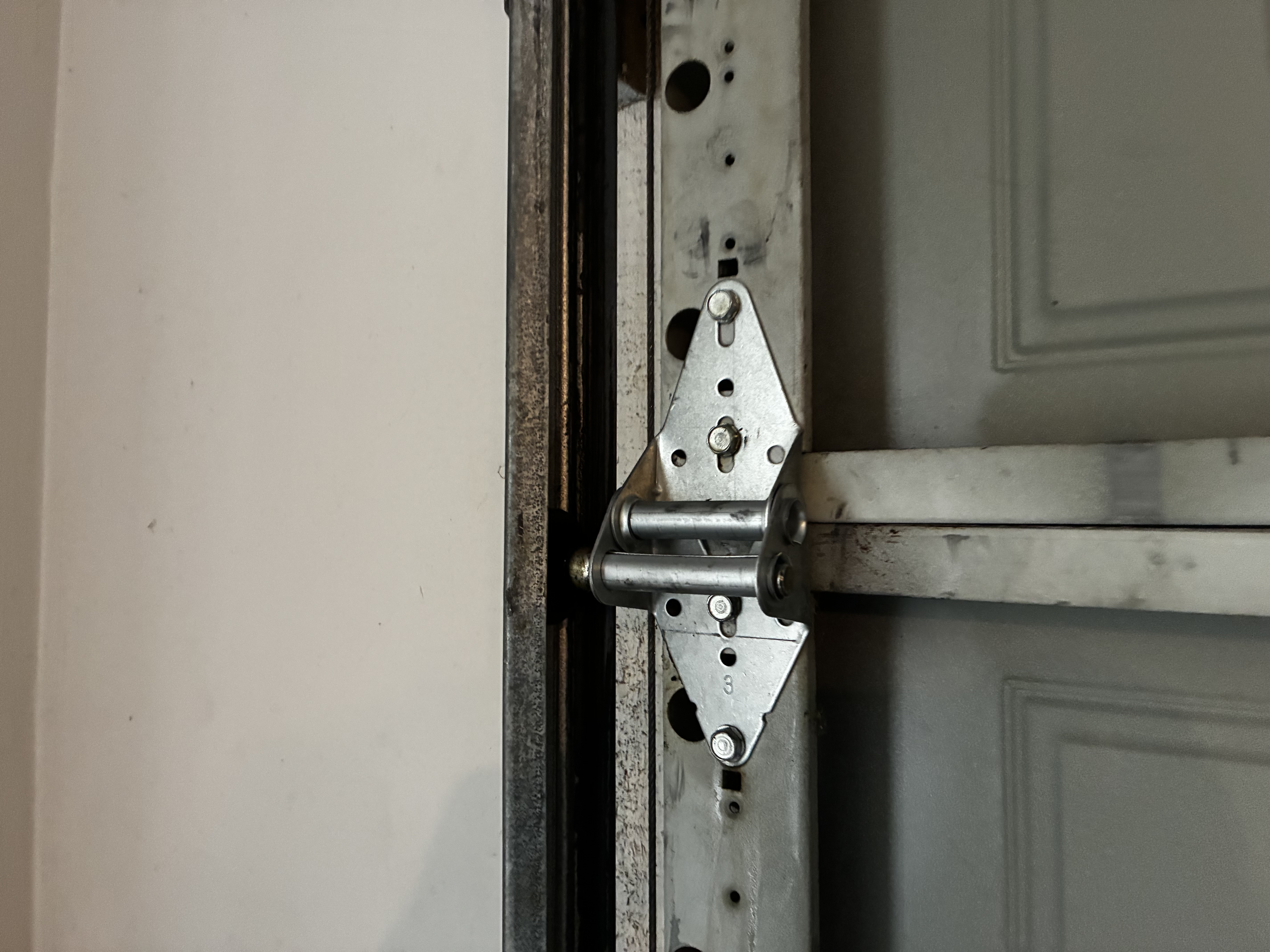 New garage door hinge installed after replacement