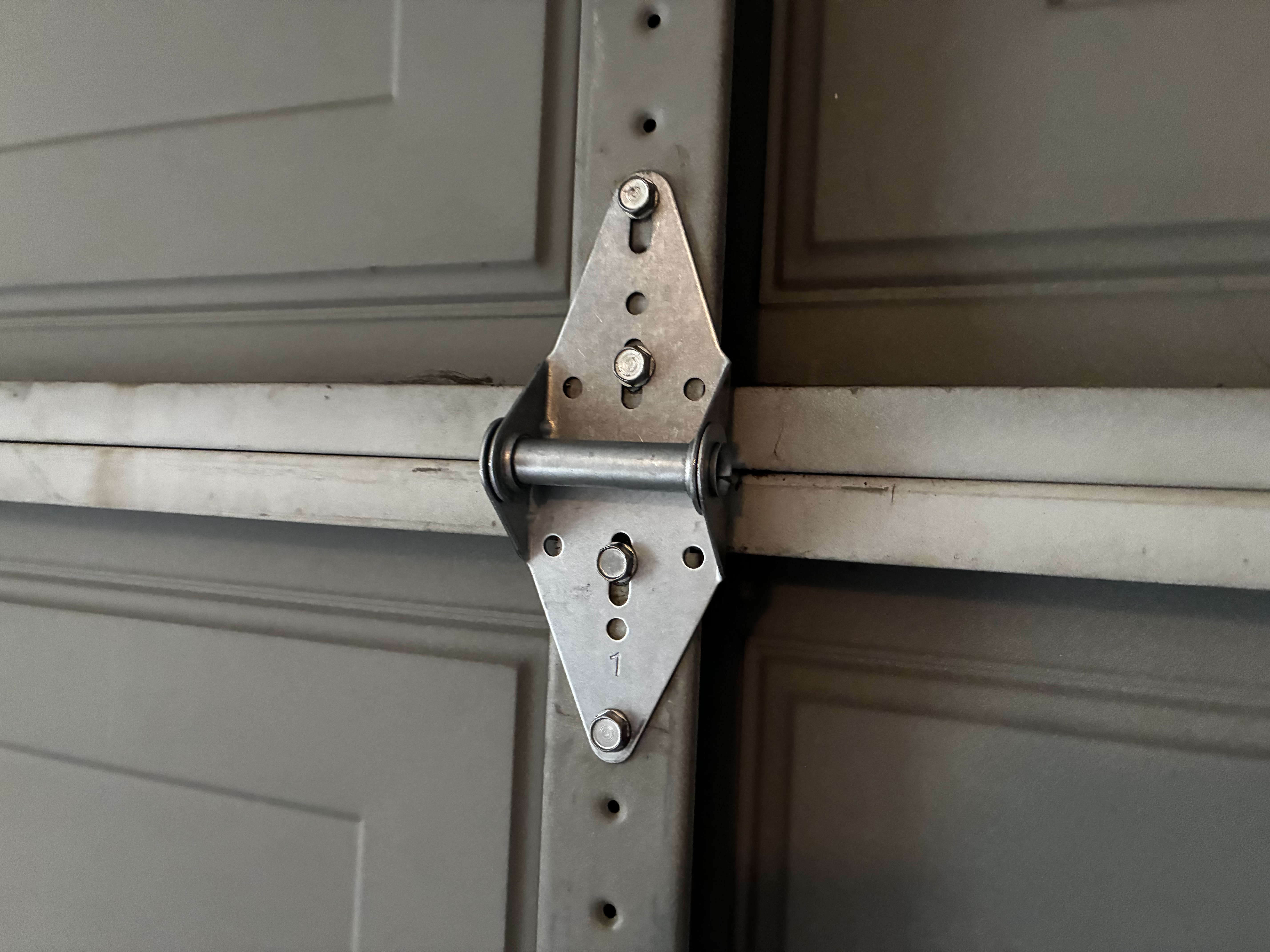 New garage door hinge 2 installed after replacement