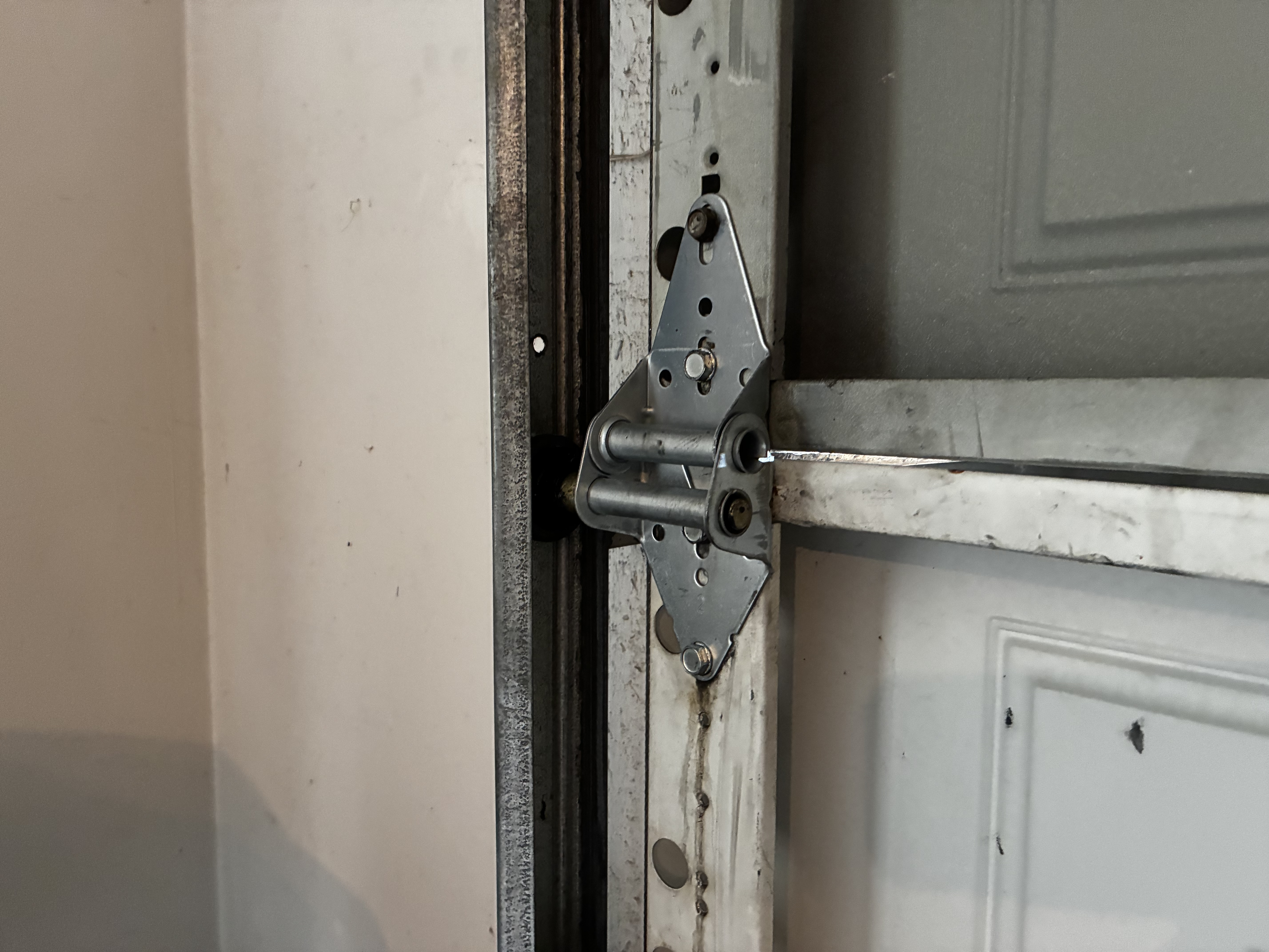 New garage door hinge 3 installed after replacement