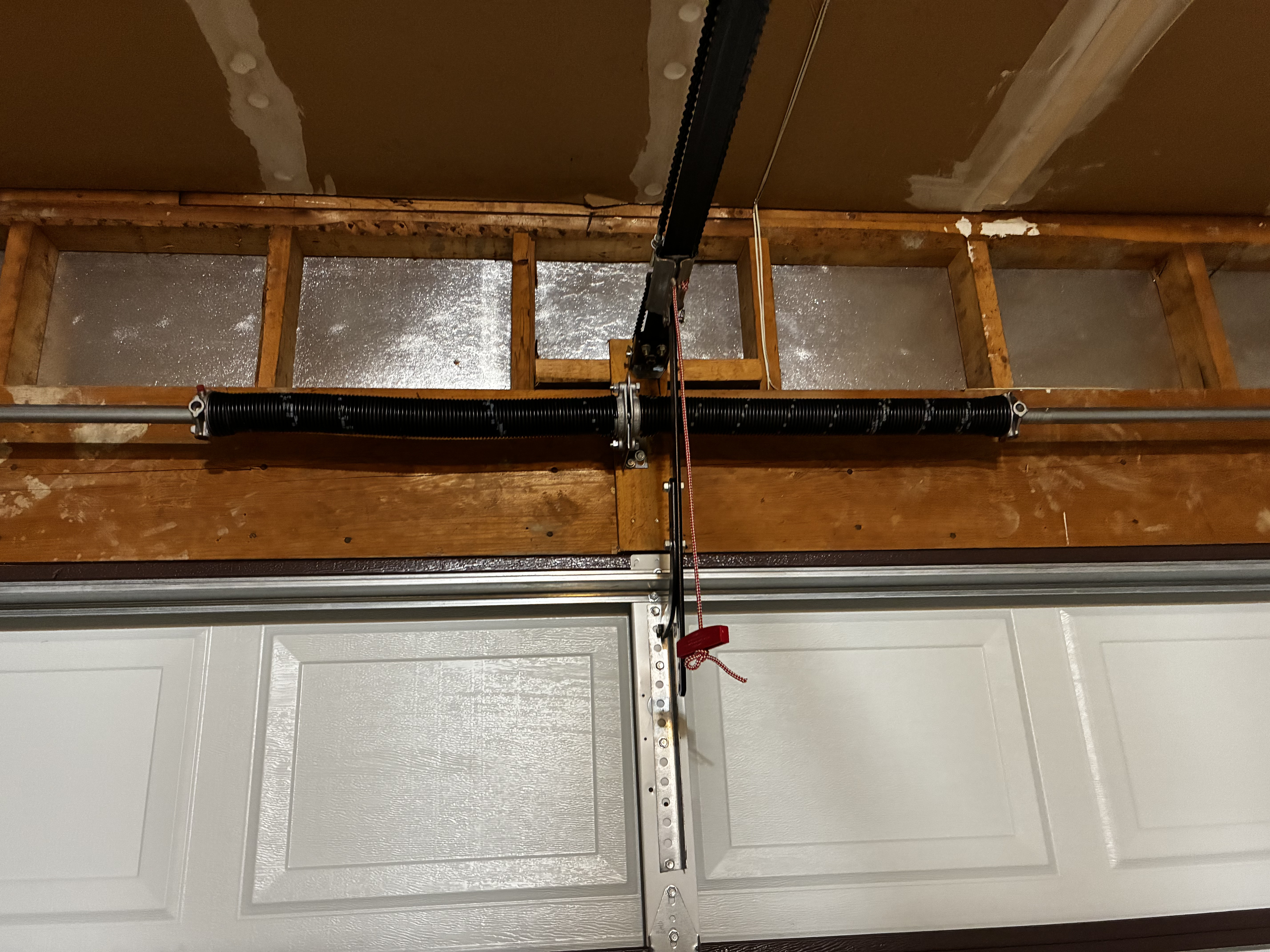 Stretched garage door torsion spring before tension adjustment